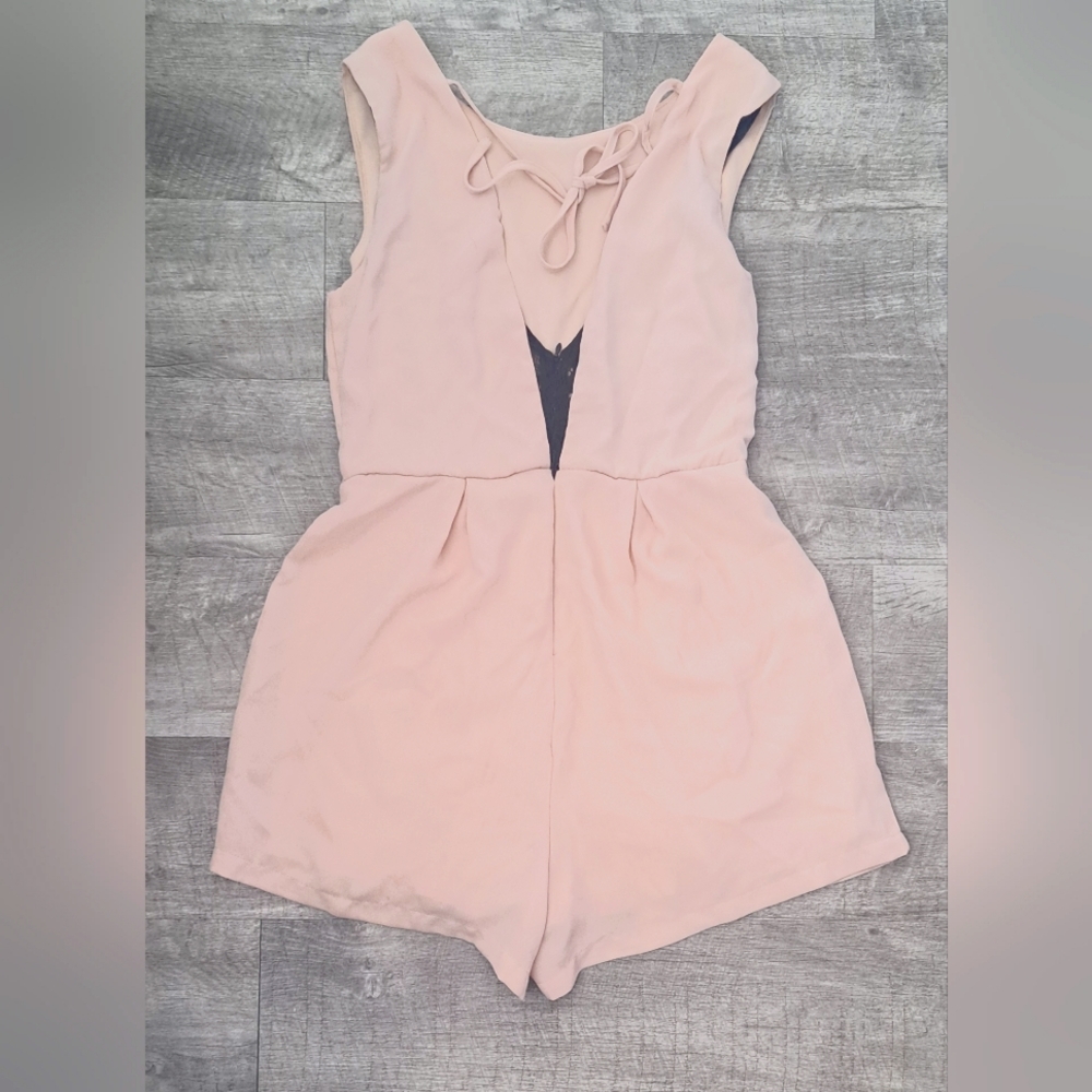 PERFECT FOR A NIGHT OUT. VERY LIGHT PINK SLEEVELESS, HIGH NECK, LOW BACK SIZE ME